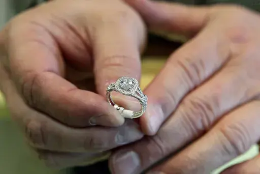A jewelers displays an engagement ring on May 14, 2014, in Jacksonville, N.C. (Maria Sestito/The Daily News via AP, File)