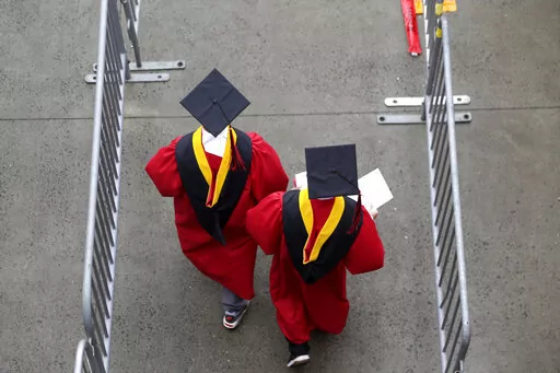 New graduates walk into the High Point Solutions Stadium before the start of the Rutgers University graduation ceremony in Piscataway Township, N.J., on May 13, 2018. The Supreme Court is about to hear arguments over President Joe Biden’s student debt relief plan. It's a plan that impacts millions of borrowers who could see their loans wiped away or reduced. (AP Photo/Seth Wenig, File)