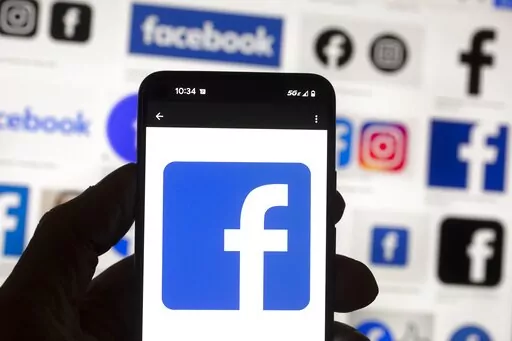 The Facebook logo is seen on a cell phone on Oct. 14, 2022, in Boston. A Washington state judge on Wednesday, Oct. 26, fined Facebook parent company Meta nearly $25 million for repeatedly and intentionally violating campaign finance disclosure law, in what is believed to be the largest campaign finance penalty in U.S. history. (AP Photo/Michael Dwyer, File)