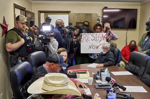 In this photo provided by the Southwest Ledger, people from Idabel, Okla., call for the resignation of several McCurtain County officials, early Monday, April 17, 2023, after tapes with the officials' racist comments surfaced over the weekend. (Christopher Bryan/Southwest Ledger via AP)