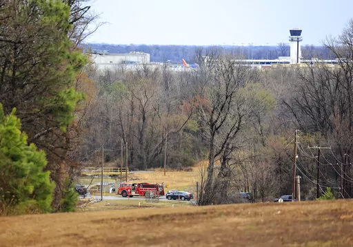 Emergency vehicles appear near the location where a small aircraft crashed while taking off from the Bill and Hillary Clinton National Airport in Little Rock, Ark., Wednesday Feb. 22, 2023. (Staton Breidenthal/Arkansas Democrat-Gazette via AP)
