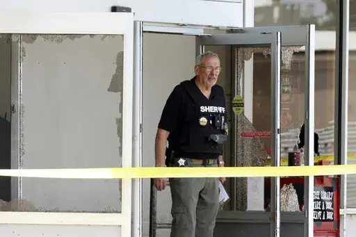 Law enforcement officers work the scene of a mass shooting at the Mad Butcher grocery store in Fordyce, Ark., Friday, June 21, 2024. Travis Eugene Posey, accused of killing four people and injuring 10 others, pleaded not guilty to charges during his first court appearance on Tuesday, June 25. (Colin Murphey/Arkansas Democrat-Gazette via AP, File)