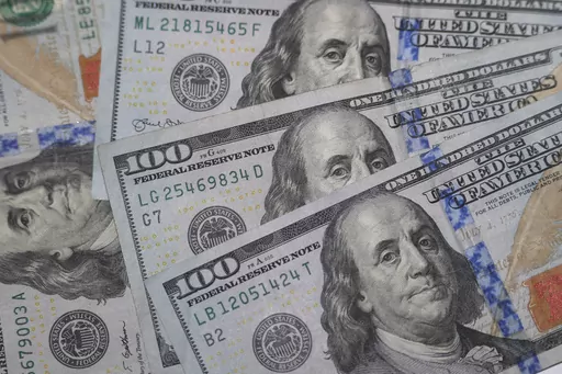 This Jan. 22, 2020, file photo shows the likeness of Benjamin Franklin on $100 bills in Dallas. When parents are stressed about finances, they can unintentionally pass on that concern to their children. To prevent that kind of worry, parents can talk about money early with their children to set a baseline for financial discussions. If parents aren’t sure of financial topics themselves, they can learn together with their children, turning it into a fun family project. Then, if financial hardshi