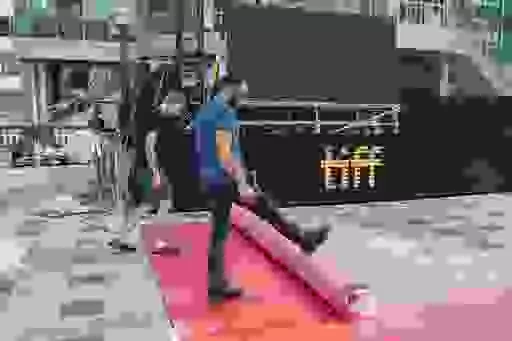 Workers roll out a red carpet ahead of the opening night of the 48th edition of the Toronto International Film Festival (TIFF) in Toronto, on Thursday, Sept. 7, 2023. The festival runs through Sept. 17. (Spencer Colby/The Canadian Press via AP)