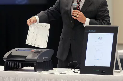 A Smartmatic representative demonstrates his company's system which has scanners and touch screens with printout options, at a meeting of the Secure, Accessible & Fair Elections Commission on Aug. 30, 2018, in Grovetown, Ga. Fox News agreed Wednesday, April 26, 2023, to hand over reams of documents produced during the just-settled defamation lawsuit between Dominion Voting Machines to another voting technology firm, Smartmatic, which in a $2.7 billion suit accuses the cable news giant of damagin