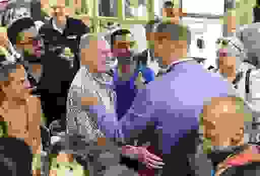 The Prince of Wales, right, greets with Paul Gascoigne, left, during a visit to a Pret A Manger store in Bournemouth, Dorset, Thursday Sept. 7, 2023, to meet with national and local businesses pledging their support to the Prince's Homewards project in Bournemouth, Christchurch and Poole. (Chris Jackson/PA via AP)