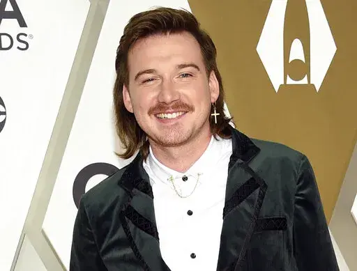 Morgan Wallen arrives at the 53rd annual CMA Awards on Nov. 13, 2019, in Nashville, Tenn. The Grand Ole Opry, country music's most historic and storied stage, is getting heavy criticism for an appearance by the country star. Wallen's surprise performance has given many the impression that the institution has given the star its blessing and a path to reconciliation after he was caught on camera last year using a racial slur. (Photo by Evan Agostini/Invision/AP, File)