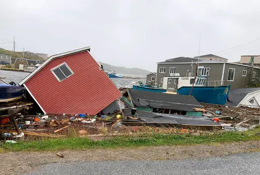 This photo provided by Pauline Billard shows destruction caused by Hurricane Fiona in Rose Blanche, 45 kilometers (28 miles)  east of Port aux Basques, Newfoundland and Labrador, Saturday, Sept. 24, 2022. (Pauline Billard via AP)