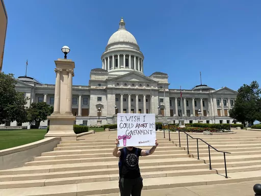 A demonstrator holds a sign outside the Arkansas state Capitol in Little Rock, Ark. on June 24, 2022, protesting the U.S. Supreme Court's decision overturning Roe v. Wade. A monument marking the number of abortions performed in Arkansas before Roe v. Wade was struck down would be built near the state Capitol under a bill lawmakers sent to Gov. Sarah Huckabee Sanders on Tuesday, March 14, 2023. (AP Photo/Andrew DeMillo, File)