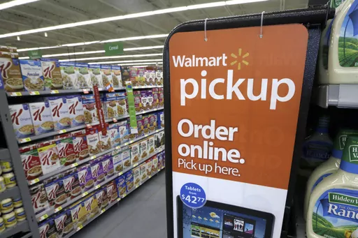 A sign encouraging customers to order grocery items online and pick them up at a store is displayed at a WalMart Neighborhood Market in Bentonville, Ark., Thursday, June 4, 2015. Walmart is the latest company to join the growing flock of major advertisers to pull spending from X, Elon Musk’s beleaguered social media company, amid concerns about hate speech — as well as reaching a sizeable audience on the platform. (AP Photo/Danny Johnston, File)