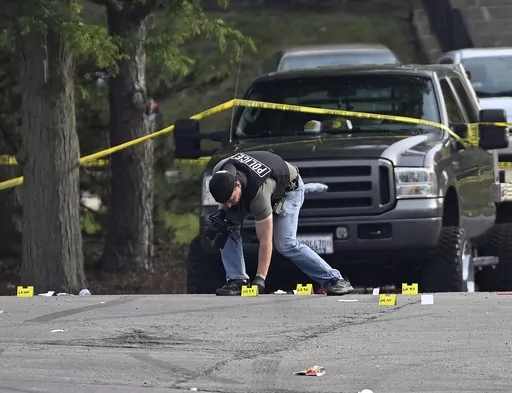 A police officer works the scene of an overnight mass shooting at a strip mall in Willowbrook, Ill., June 18, 2023. A suburban Chicago teen is facing weapons charges in connection with a June shooting where one person died and 22 others were injured, authorities said Friday, Oct. 6, 2023. (AP Photo/Matt Marton, File)