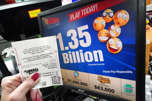 A customer at the Cranberry Super Mini Mart in Cranberry, Pa., shows her Mega Millions ticket on Thursday, Jan. 12, 2023. (AP Photo/Gene J. Puskar)