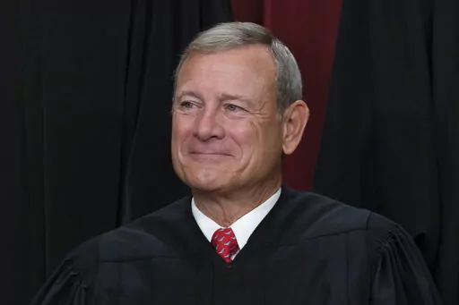 Chief Justice of the United States John Roberts joins other members of the Supreme Court as they pose for a new group portrait, at the Supreme Court building in Washington, Oct. 7, 2022. (AP Photo/J. Scott Applewhite, File)