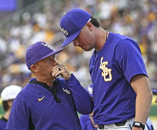 LSU pitching coach Wes Johnson, left, speaks with starting pitcher Paul Skenes (20) in the bullpen before an NCAA college baseball game against Tennessee, March 30, 2023, in Baton Rouge, La. Georgia has hired Johnson to take over the Bulldogs' program. Johnson replaces Scott Stricklin, who was fired last month. (Hilary Scheinuk/The Advocate via AP, File)