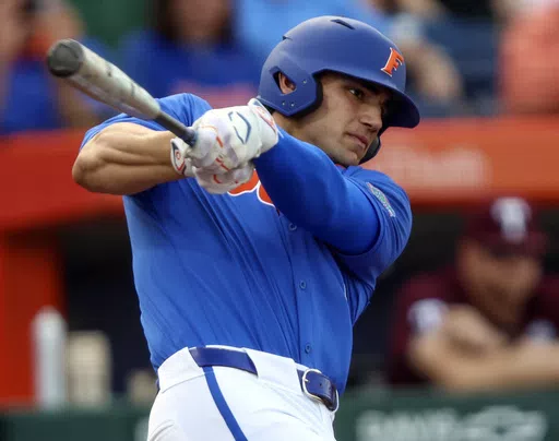 Florida utility Jac Caglianone hits a single in the first inning of an NCAA baseball game against Texas A&M, March 16, 2024, in Gainesville, Fla. Caglianone tied the NCAA record when he hit a home run for a ninth straight game in a loss at Vanderbilt, Friday, April 19, 2024. (AP Photo/Gary McCullough, File)