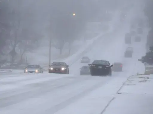 Motorists drive during a sleet storm in Tulsa, Okla,, Wednesday, Feb. 23, 2022. (Stephen Pingry/Tulsa World via AP)