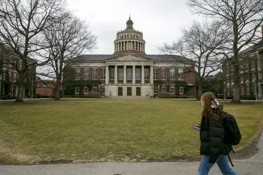 A student walks by the Rush Rhees Library at the University of Rochester, Feb. 22, 2023. (AP Photo/Ted Shaffrey, File)
