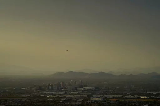 Clouds surround downtown Phoenix at sunset, Sunday, July 30, 2023. The city so far this year has seen 52 days of highs at 110 degrees or over and is expected to hit that mark again on both Saturday, Sept. 9, and Sunday. (AP Photo/Matt York)
