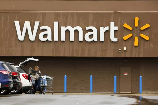 A shopper loads her car after shopping at a Walmart in Pittsburgh, Thursday, Feb. 22, 2018. Walmart announced Tuesday, April 30, 2024, is closing its health centers and virtual care service, as the retail giant has struggled to find success with the offerings. AP Photo/Gene J. Puskar, File)