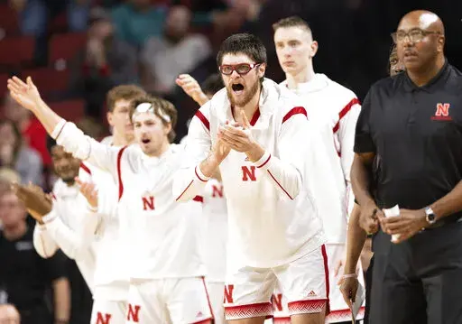 Alongside teammates on the bench, Nebraska's Wilhelm Breidenbach, second from front right, celebrates after a 3-point basket against Arkansas-Pine Bluff during the second half of an NCAA college basketball game on Sunday, Nov. 20, 2022, in Lincoln, Neb. (AP Photo/Rebecca S. Gratz)