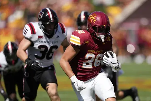 Iowa State running back Carson Hansen (26) runs from Arkansas State linebacker Charles Willekes (36) during the first half of an NCAA college football game, Saturday, Sept. 21, 2024, in Ames, Iowa. (AP Photo/Charlie Neibergall)