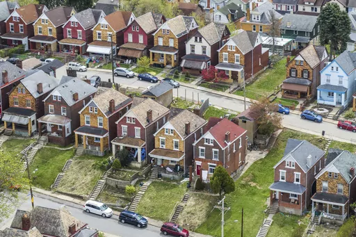 This April 12, 2021 photo shows houses in Knoxville, a neighborhood in Pittsburgh. Most older adults ages 50 to 80 say it’s important to stay in their homes for as long as they can, according to the 2022 National Poll on Healthy Aging from the University of Michigan. But aging in place isn’t as simple as just staying home — you must consider the costs, including those for age-related home renovations, home maintenance and caregiving. (Andrew Rush/Pittsburgh Post-Gazette via AP, File)