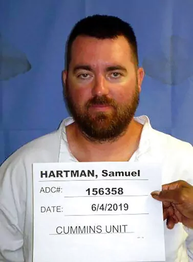 This photo provided by the Arkansas Department of Correction shows Samuel Hartman. Authorities are searching for the convicted rapist who escaped from an east Arkansas prison. The state Department of Corrections on Friday, Aug. 12, 2022, said that the 38-year-old Hartman escaped that morning from the East Arkansas Regional Unit in Brickeys, Ark. The prison is located about 96 miles east of Little Rock. (Arkansas Department of Correction via AP)