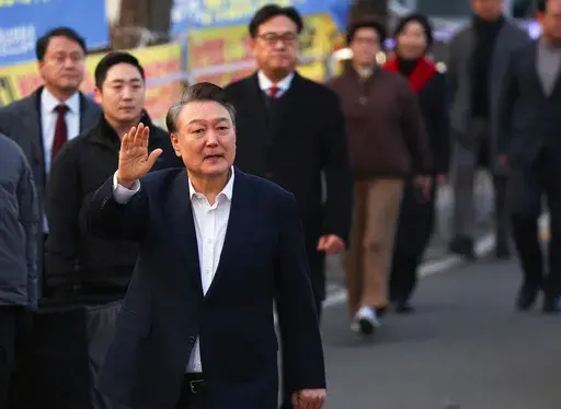 Impeached South Korean President Yoon Suk Yeol greets his supporters after he came out of a detention center in Uiwang, South Korea, Saturday, March 8, 2025. (Kim Do-hun/Yonhap via AP)