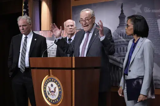 Senate Minority Leader Chuck Schumer, D-N.Y., center, is joined from left by Sen. Tim Kaine, D-Va., Sen. Peter Welch, D-Vt., and Sen. Angela Alsobrooks, D-Md., as they speak to reporters about President Donald Trump's tariffs on foreign countries, at the Capitol, in Washington, Wednesday, April 2, 2025. (AP Photo/J. Scott Applewhite)
