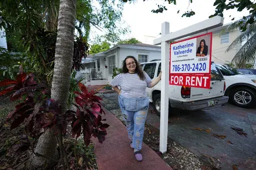 Krystal Guerra, 32, poses for a picture outside her apartment, which she has to leave after her new landlord gave her less than a month's notice that her rent would go up by 26%, Saturday, Feb. 12, 2022, in the Coral Way neighborhood of Miami. Guerra, who works in marketing while also pursuing a degree part-time, had already been spending nearly 50% of her monthly income on rent prior to the increase. Unable to afford a comparable apartment in the area as rents throughout the city have risen dra