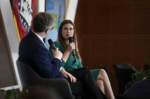 Arkansas Business Publishing Group Associate Publisher Chris Bahn, left, talks with Gov. Sarah Huckabee Sanders during a question and answer session with the Little Rock Rotary Club at the Clinton Center on Tuesday, July 18, 2023, in Little Rock, Ark. (Stephen Swofford/Arkansas Democrat-Gazette via AP)