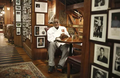 Angus Barn executive chef Walter Royal sits in his favorite spot in the Angus Barn, a Raleigh, N.C., institution, Wednesday, Feb. 19, 2020. Royal, the chef of a destination steakhouse in North Carolina who triumphed on “Iron Chef America” by cooking mostly southern dishes with ostrich meat, has died Monday, May 22, 2023, at the age of 67. The Angus Barn in Raleigh, where Royal served as executive chef since the 1990s, announced his passing on its website. (Juli Leonard/The News & Observer vi