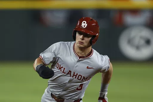 Oklahoma's John Spikerman (8) runs to third during an NCAA college baseball game against Tennessee Saturday, Feb. 17, 2024, in Arlington, Texas. Oklahoma clinched its first Big 12 regular-season championship with a three-game sweep of Baylor over the weekend. Leadoff man John Spikerman, who missed five weeks following hand surgery, is batting .407 after going 12 for his last 19.(AP Photo/Brandon Wade, File)