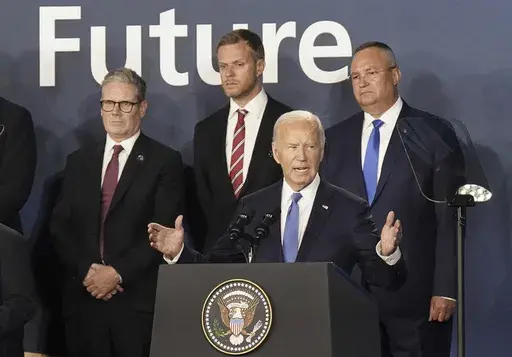Britain's Prime Minister Keir Starmer, left, looks on as U.S. President Joe Biden speaks, where he introduced Ukrainian President Volodymyr Zelenskyy during an event on the Ukraine Compact at the NATO Summit at the Walter E. Washington Convention Center, in Washington, Thursday, July 11, 2024. Biden's withdrawal from the U.S. presidential race injects greater uncertainty into the world. (Stefan Rousseau/Pool Photo via AP, File)