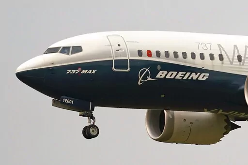 A Boeing 737 Max jet prepares to land at Boeing Field following a test flight in Seattle, Sept. 30, 2020. Boeing plans to make staffing cuts in the aerospace company's finance and human resources support services departments in 2023, with a loss of around 2,000 jobs, the company said Monday, Feb. 6, 2023. (AP Photo/Elaine Thompson, File)