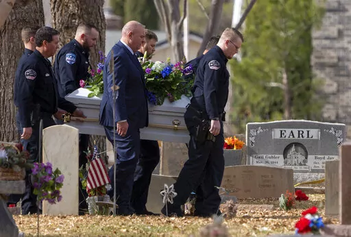 Pallbearers carry a casket to the graveside service for the Haight and Earl families in La Verkin, Utah, on Jan. 13, 2023, in La Verkin, Utah. A Utah man who killed seven family members before committing suicide earlier this month had been investigated for child abuse years prior. Police records obtained by The Associated Press shed light on Michael Haight's violent tendencies and the warning signs that authorities were aware of years before the tragic murder-suicide. (Rick Egan/The Salt Lake Tr