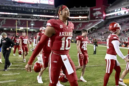 Arkansas quarterback Taylen Green (10) heads to the locker room after defeating Louisiana Tech 35-14 during an NCAA college football game Saturday, Nov. 23, 2024, in Fayetteville, Ark. (AP Photo/Michael Woods)