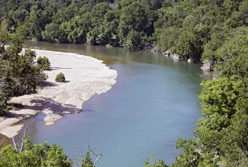 The Illinois River as seen from Goat's Bluffat the J.T. Nickel Family Nature and Wildlife Preserve in Cherokee County, Okla., July 18, 2019. A federal judge is giving Oklahoma and nearly a dozen poultry companies, including the world’s largest poultry producer, Tyson Foods, an additional 90 days to reach an agreement on plans to clean a watershed polluted by chicken litter. U.S. District Judge Gregory Frizzell on Friday, March 17, 2023 scheduled a June 16 hearing in Tulsa, saying both sides re
