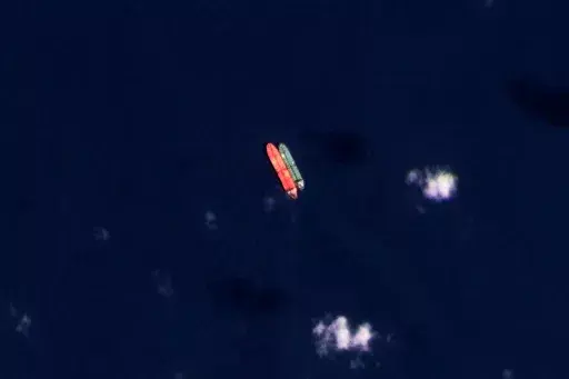 In this satellite photo provided by Planet Labs PBC, vessels identified as the Virgo, left, and the Suez Rajan, by the advocacy group United Against Nuclear Iran, are seen in the South China Sea on Feb. 13, 2022. A Greek shipper has pleaded guilty to a charge over it smuggling sanctioned Iranian crude oil and agreed to pay a $2.4 million fine, U.S. federal court papers seen Thursday, Sept. 7, 2023 by The Associated Press show. (Planet Labs PBC via AP, File)