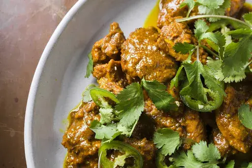 This image released by Milk Street shows a recipe for chicken vindaloo. (Milk Street via AP)