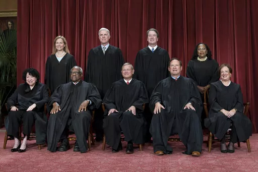 Members of the Supreme Court sit for a new group portrait following the addition of Associate Justice Ketanji Brown Jackson, at the Supreme Court building in Washington, Friday, Oct. 7, 2022. Bottom row, from left, Associate Justice Sonia Sotomayor, Associate Justice Clarence Thomas, Chief Justice of the United States John Roberts, Associate Justice Samuel Alito, and Associate Justice Elena Kagan. Top row, from left, Associate Justice Amy Coney Barrett, Associate Justice Neil Gorsuch, Associate 