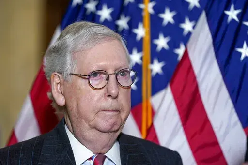 Senate Minority Leader Mitch McConnell of Ky., arrives to speak to reporters on Capitol Hill in Washington, Tuesday, Feb. 8, 2022. Senate Republicans blame the Republican National Committee. The Republican National Committee blames two Republican House members. They blame former President Donald Trump. And Trump blames McConnell. In the midst of the GOP’s first major election year blowup, each group believes it represents the real Republican Party and its best interests in 2022.  (AP Photo/Sus