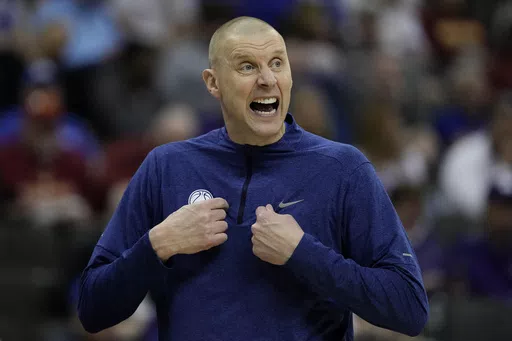 BYU head coach Mark Pope talks to his players during the first half of an NCAA college basketball game against UCF Wednesday, March 13, 2024, in Kansas City, Mo. Kentucky has hired BYU’s Mark Pope as men’s basketball coach, bringing home a member of the Wildcats’ 1996 national championship team to succeed John Calipari. The school announced Pope’s hiring in a release Friday morning, April 12, but did not mention any contract details. The 51-year-old Pope will be introduced at a later dat