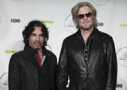 Hall of Fame Inductees, Hall & Oates, John Oates and Daryl Hall appear in the press room at the 2014 Rock and Roll Hall of Fame Induction Ceremony on April, 10, 2014, in New York. Hall has sued his longtime music partner John Oates, arguing that his plan to sell off his share of a joint venture would violate a business agreement the duo had. (Photo by Andy Kropa/Invision/AP, File)