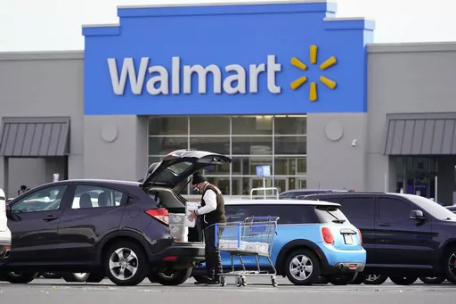 A customer loads a car after shopping at a Walmart in Philadelphia, Nov. 17, 2021. Walmart, the nation's largest private employer, is expanding nationwide its health care coverage next month for employees who want to enlist the services of a doula, a person trained to assist women during pregnancies. (AP Photo/Matt Rourke, file)