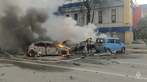 In this photo taken from video released by Russia Emergency Situations Ministry telegram channel on Saturday, Dec. 30, 2023, firefighters extinguish burning cars after shelling in Belgorod, Russia. Russian air defenses downed dozens of Ukrainian drones aimed at occupied Crimea and southern Russia, officials said Friday Jan. 5, 2024. (Russia Emergency Situations Ministry telegram channel via AP, File)