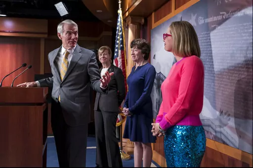 From left, Sen. Rob Portman, R-Ohio, Sen. Tammy Baldwin, D-Wis., Sen. Susan Collins, R-Maine, and Sen. Kyrsten Sinema, D-Ariz., talk with reporters following Senate passage of the Respect for Marriage Act, at the Capitol in Washington, Tuesday, Nov. 29, 2022. (AP Photo/J. Scott Applewhite)