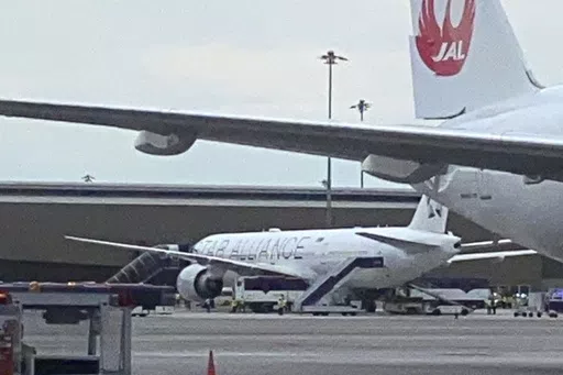 The Boeing 777-300ER aircraft of Singapore Airlines, flight SQ321 from Heathrow is seen on tarmac after requesting an emergency landing at Bangkok's Suvarnabhumi International airport, Thailand, Tuesday, May 21, 2024. One person has died aboard a London-Singapore flight that encountered severe turbulence, Singapore Airlines said Tuesday, in which the plane apparently plummeted for a number of minutes before it was diverted to Bangkok, where emergency crews rushed to help injured passengers amid 