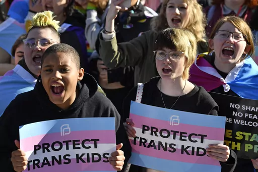 Protesters of Kentucky Senate Bill SB150, known as the Transgender Health Bill, cheer on speakers during a rally on the lawn of the Kentucky Capitol in Frankfort, Ky., March 29, 2023. Kentucky's ban on gender-affirming care for young transgender people was restored Friday, July 14, when a federal judge lifted an injunction he issued the previous month that had temporarily blocked the restrictions. (AP Photo/Timothy D. Easley, File)