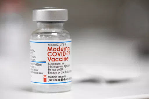 A vial of the Moderna COVID-19 vaccine is displayed on a counter at a pharmacy in Portland, Ore., Monday, Dec. 27, 2021. U.S. regulators have granted full approval to Moderna’s COVID-19 vaccine after reviewing additional data on its safety and effectiveness. The decision Monday, Jan. 31, 2022 by the Food and Drug Administration comes after many tens of millions of Americans have already received the shot under its original emergency authorization. Full approval means FDA has completed the same